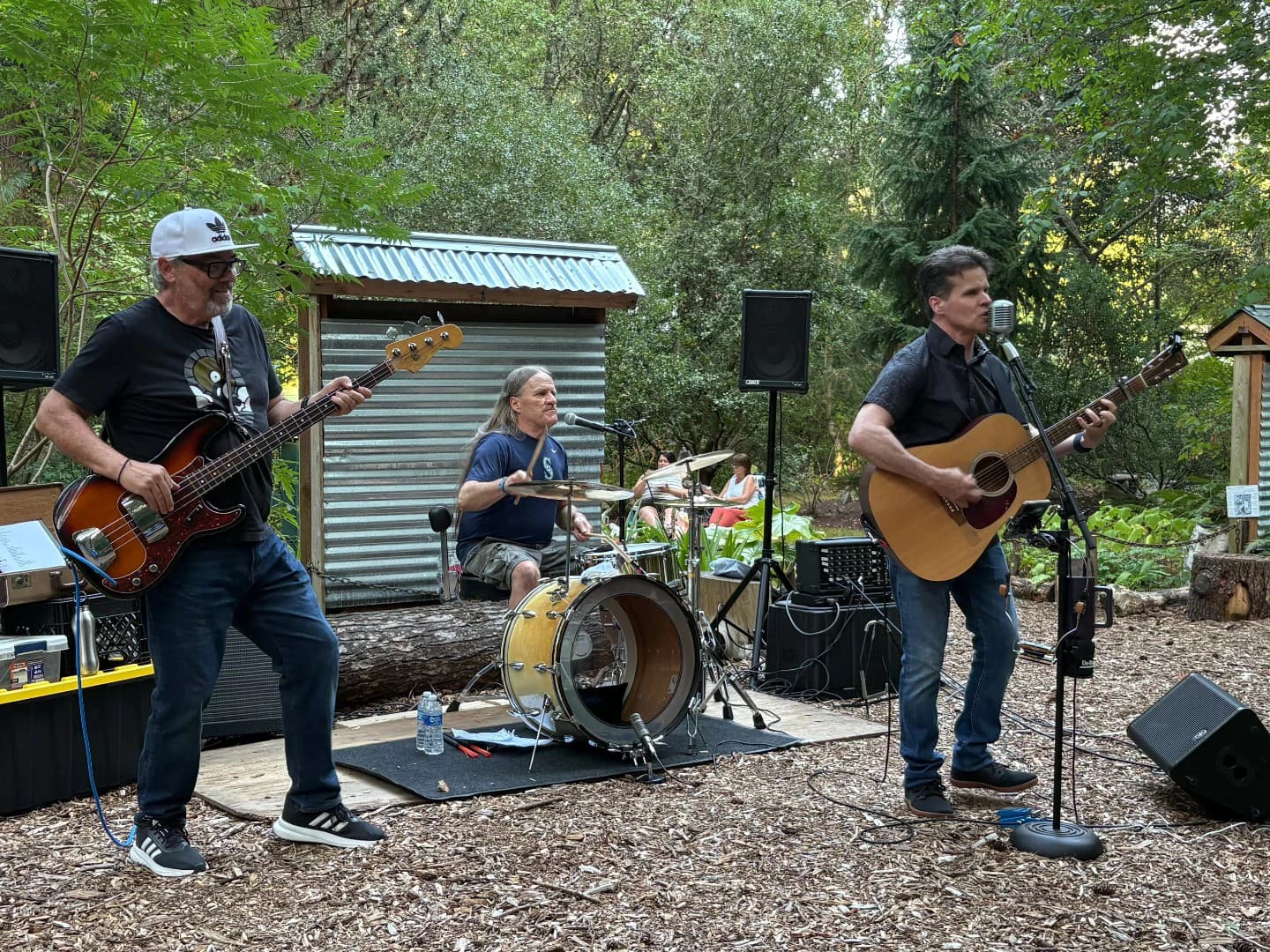 Rusty Cage playing an outdoor set in the woods near Shoreline